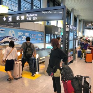 Cargados con el equipaje y a punto de tomar el tren para viajar desde el aeropuerto de Narita a Tokio