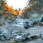 Paseando vestidos con yukata por el parque Sainokawara de Kusatsu Onsen durante la época del momiji (enrojecimiento de las hojas de los árboles).